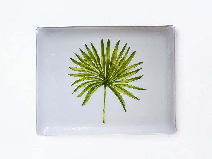 A rectangular white acrylic serving tray with rounded corners, featuring a printed green palm leaf design in the center, set against a plain white background.