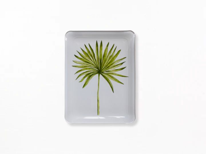 A square acrylic tray with rounded corners, featuring a printed green palm leaf design on a light gray background, set against a solid white backdrop.