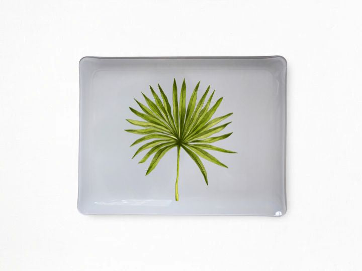 A rectangular gray acrylic tray with rounded corners, featuring a printed green palm frond design in the center, set against a plain white background.